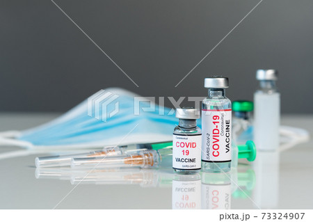 coronavirus covid-19 vaccine bottles and syringe injection and medical mask coronavirus covid-19 vaccine bottles and syringe injection and medical mask 73324907