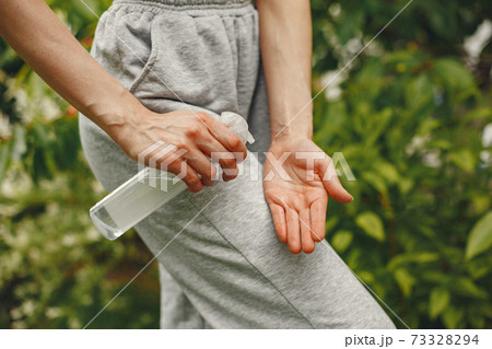 Woman holding antiseptic in her hands Woman holding antiseptic in her hands 73328294
