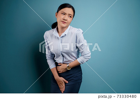 Asian woman holding hands pressing her crotch. 73330480