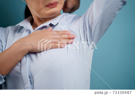 Close up shot of woman testing smelling her armpit. Close up shot of woman testing smelling her armpit. 73330487