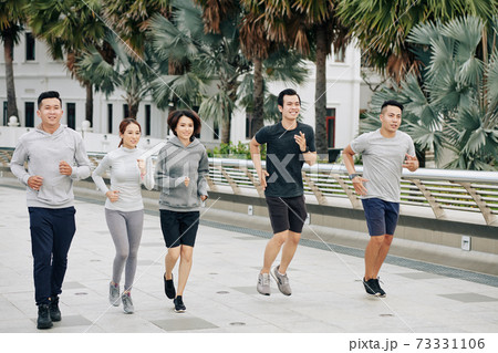 Fit Asian friends jogging together Fit Asian friends jogging together 73331106