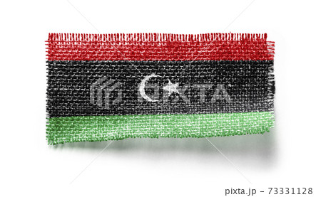 Libya flag on a piece of cloth on a white background Libya flag on a piece of cloth on a white background 73331128
