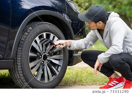 【洗車】SUV ホイールを洗う男性 73331290