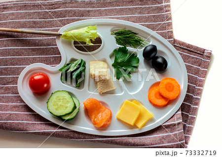 palette with colorful vegetables, fish and greens, creative food design, funny and healthy meal for kids. palette with colorful vegetables, fish and greens, creative food design, funny and healthy meal for kids. 73332719