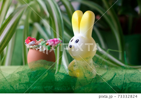easter celebration concept. toy bunny and decorated easter egg on grass. happy easter and spring easter celebration concept. toy bunny and decorated easter egg on grass. happy easter and spring 73332824