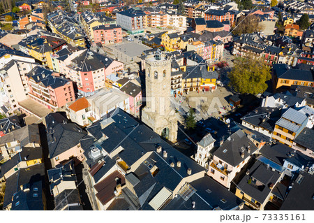 Aerial view of Spanish town of Puigcerda with medieval church belfry 73335161