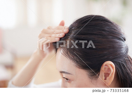 髪の毛を気にするミドル女性 髪の毛を気にするミドル女性 73335168