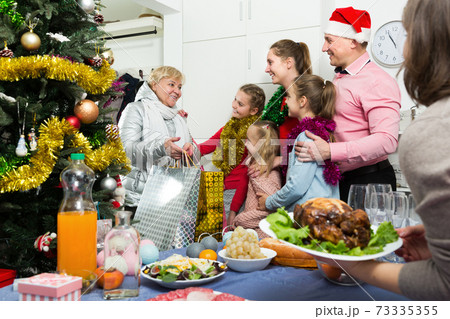 Happy family with kids meeting at home interior at Christmas 73335355