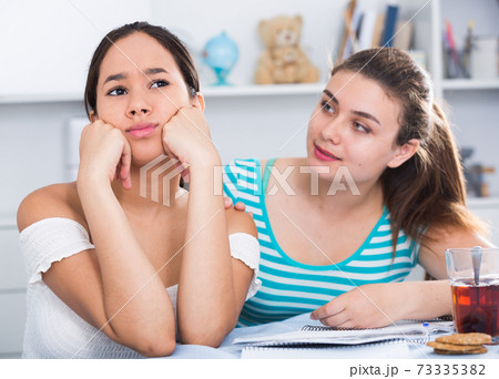 Teen girl trying to apologize after dispute 73335382