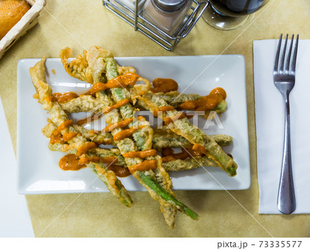 Asparagus fried in batter with romesco sauce Asparagus fried in batter with romesco sauce 73335577