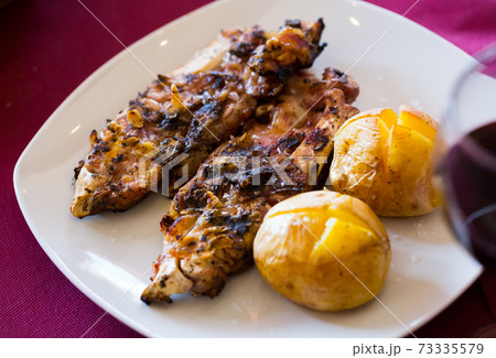 Grilled pettitoes with baked potatoes 73335579