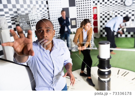 Portrait of man in quest room with other multiracial people 73336178