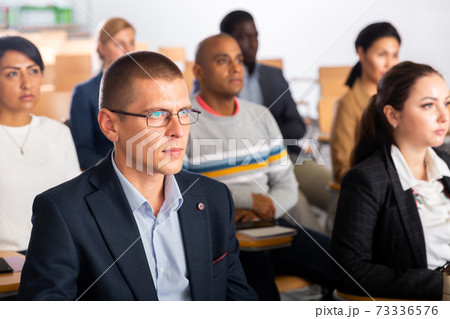 Focused businessman listening to speaker at business conference Focused businessman listening to speaker at business conference 73336576