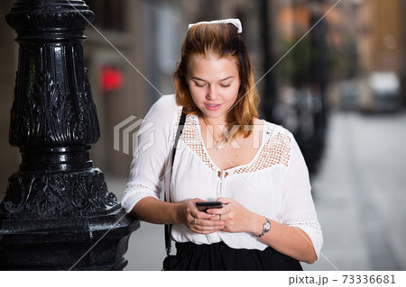 Portrait of smiling girl using mobile phone Portrait of smiling girl using mobile phone 73336681