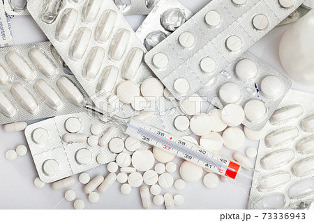 Many different pills and medical capsules close up 73336943
