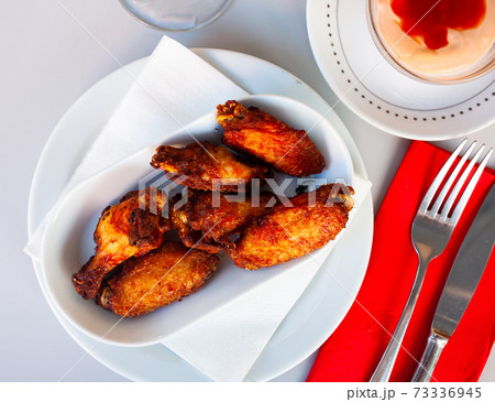 Plate of tasty snack – roasted chicken wings 73336945