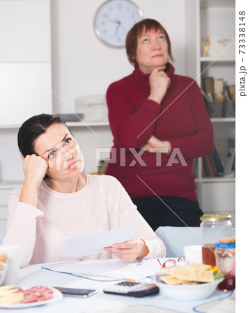 Unhappy woman with documents, family quarrel Unhappy woman with documents, family quarrel 73338148