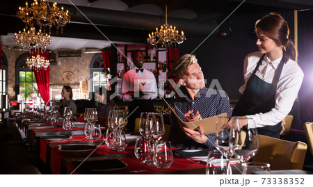 Man holding menu and ordering food 73338352