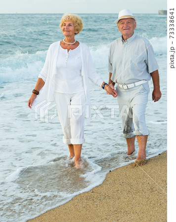 mature man and woman on the sea shore barefoot mature man and woman on the sea shore barefoot 73338641