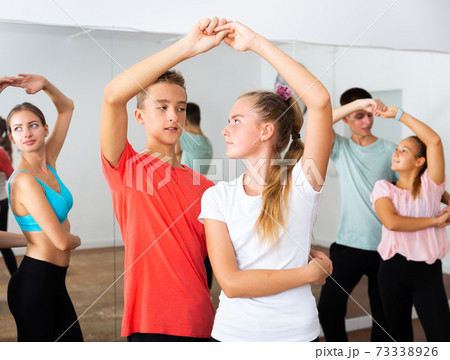 Teenagers dancing in pairs in choreography class Teenagers dancing in pairs in choreography class 73338926