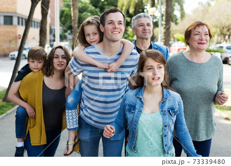 Cheerful males and females walking Cheerful males and females walking 73339480