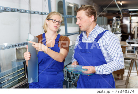 Woman and man working in glass workshop Woman and man working in glass workshop 73340274
