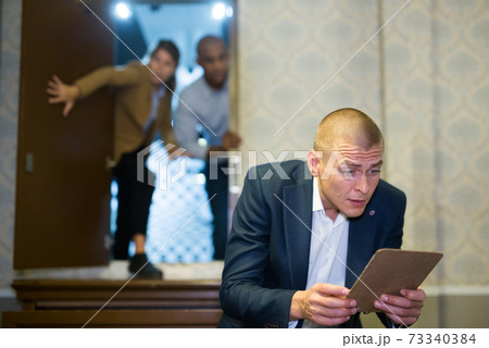 Pensive man solving conundrum in quest room 73340384