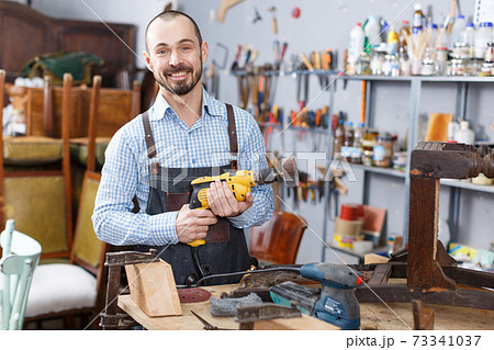 Craftsman holding carpentry tools Craftsman holding carpentry tools 73341037