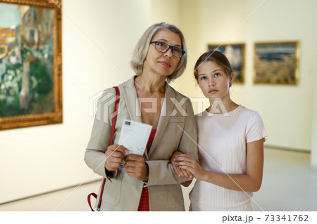 Woman and girl visiting museum Woman and girl visiting museum 73341762