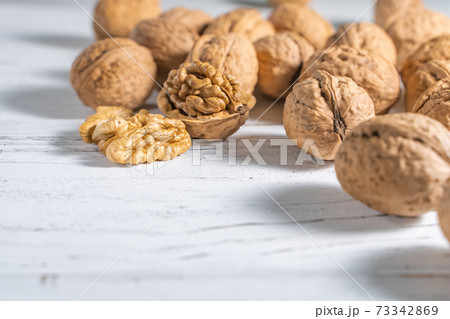 Walnuts kernels on white wooden desk, stock photo Walnuts kernels on white wooden desk, stock photo 73342869