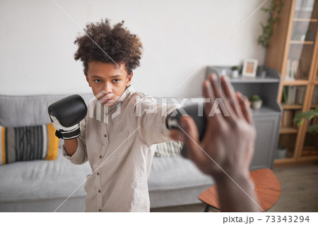 Boy Working On Boxing Punch Boy Working On Boxing Punch 73343294