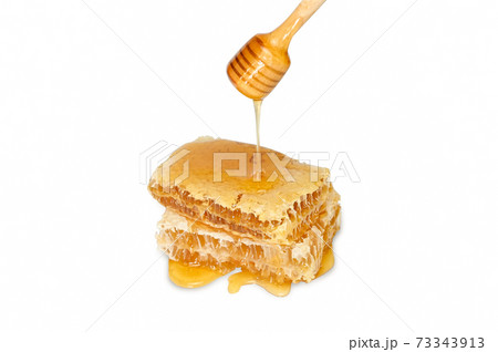 Honeycomb and honey dripping isolated on a white background with clipping path. 73343913