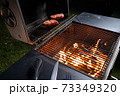 Meat on the grill, cooking in the open air in the evening 73349320