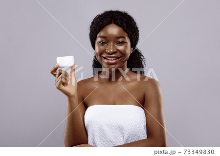 Skin Care Concept. Attractive Young Black Lady Holding Jar With Face Cream Skin Care Concept. Attractive Young Black Lady Holding Jar With Face Cream 73349830