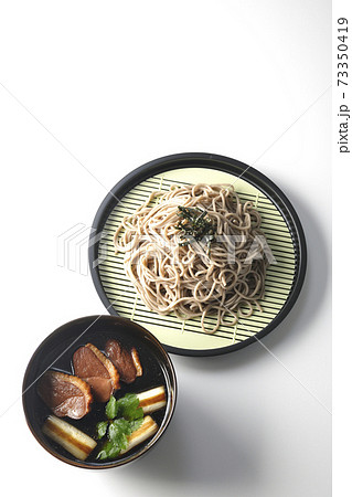 ロースト鴨肉と焼長葱と三つ葉の入った鴨せいろ蕎麦を白背景で撮影(俯瞰) ロースト鴨肉と焼長葱と三つ葉の入った鴨せいろ蕎麦を白背景で撮影(俯瞰) 73350419