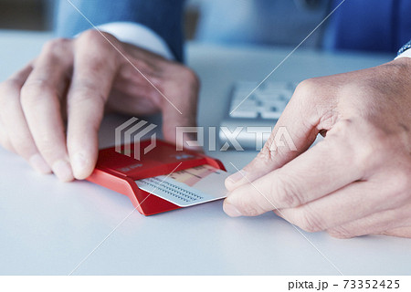 man insearting an electronic identification in a reader man insearting an electronic identification in a reader 73352425