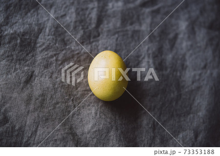 Organic naturally dyed yellow and gray Easter eggs. 73353188