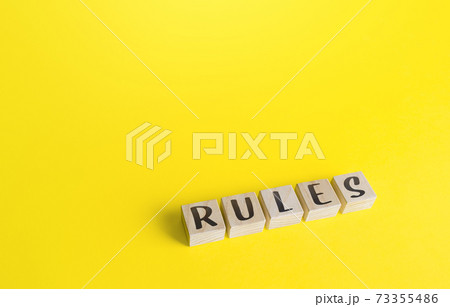 Blocks with the word Rules on yellow background. Laws and community ethics norms. Terms of the contract and the obligations of the parties. Control and monitoring, standardization. Order, discipline. Blocks with the word Rules on yellow background. Laws and community ethics norms. Terms of the contract and the obligations of the parties. Control and monitoring, standardization. Order, discipline. 73355486