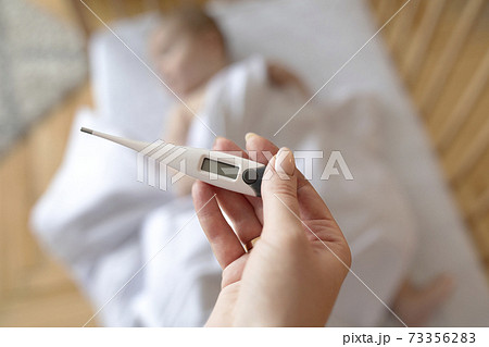 Electronic thermometer with empty display in mother hand Electronic thermometer with empty display in mother hand 73356283