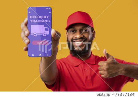 Black man holding mobile phone with delivery tracking app 73357134