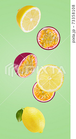 Fresh falling lemon and passionfruits isolated on white Fresh falling lemon and passionfruits isolated on white 73358108