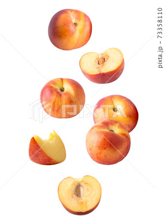 Falling sliced peach fruit isolated on white Falling sliced peach fruit isolated on white 73358110