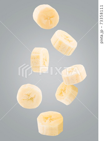 Falling sliced fresh banana isolated on white Falling sliced fresh banana isolated on white 73358111