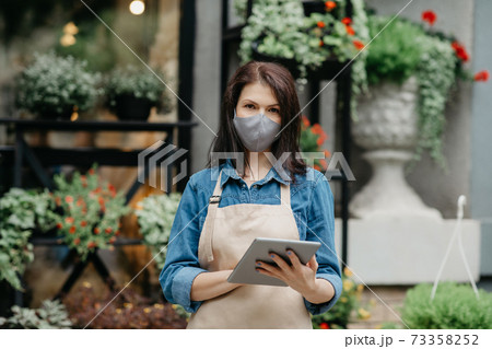 People, business, technology, sale and floristry. Serious young woman writes message People, business, technology, sale and floristry. Serious young woman writes message 73358252