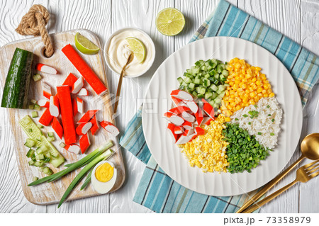 Crab salad of surimi sticks on a white plate 73358979