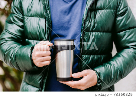 Man Holding Coffee Mug mockup outdoors 73360829