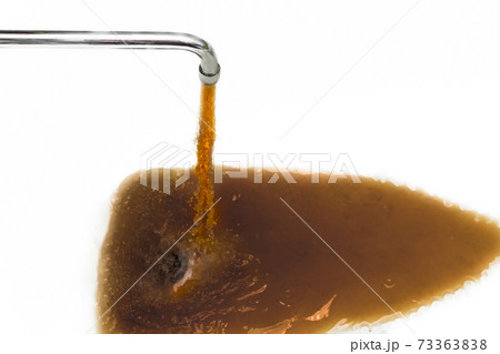 Rusty or dirty water flowing from a tap into a white bathtub or sink 73363838