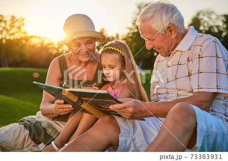 Girl with grandparents, photo album. Girl with grandparents, photo album. 73363931