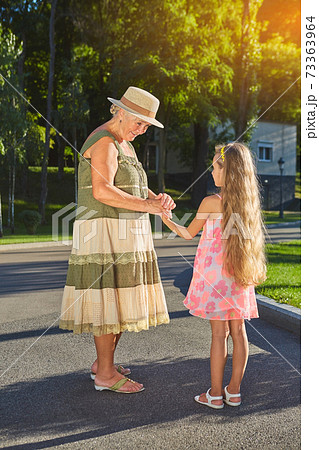 Senior woman smiling to granddaughter. Senior woman smiling to granddaughter. 73363964