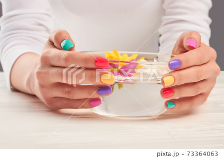 Aroma bath in manicured hands. Aroma bath in manicured hands. 73364063